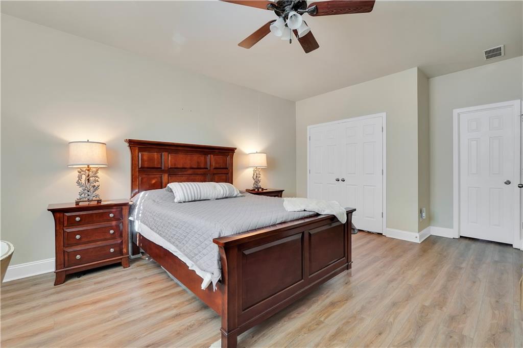 340 Roland Manor Drive Dacula, GA 30019 - Photo 21 of 50 a bed room with a bed and a ceiling fan