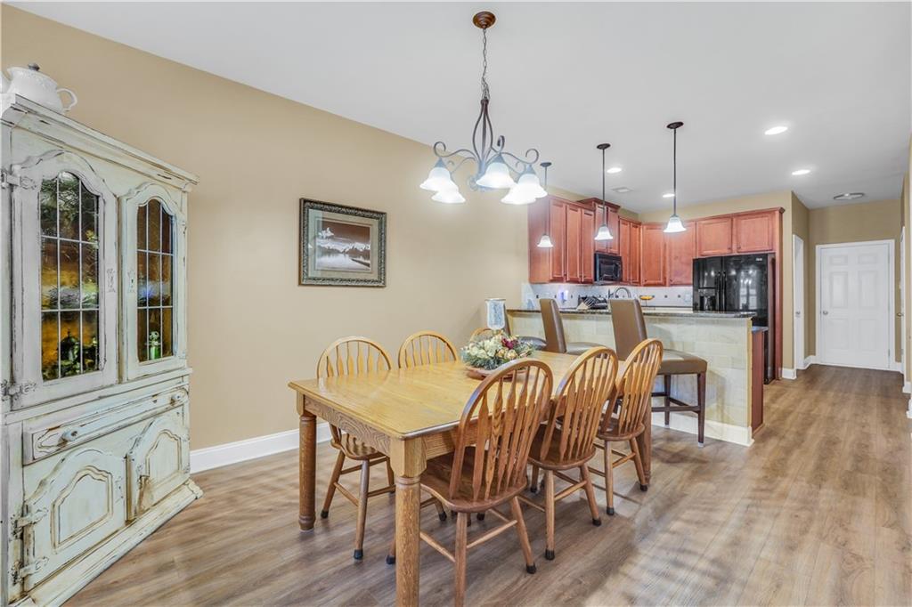 340 Roland Manor Drive Dacula, GA 30019 - Photo 24 of 50 a view of a dining room with furniture window and wooden floor