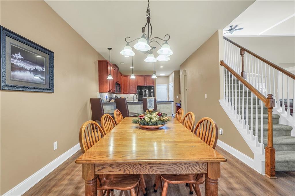 340 Roland Manor Drive Dacula, GA 30019 - Photo 25 of 50 a view of a dining room with furniture and wooden floor