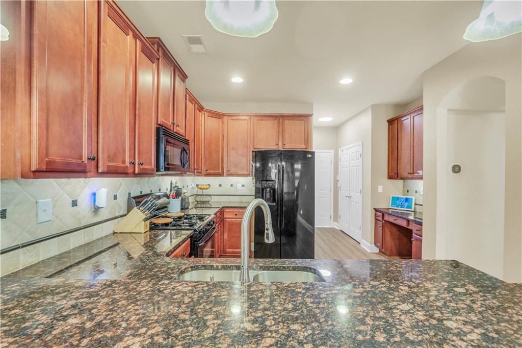 340 Roland Manor Drive Dacula, GA 30019 - Photo 30 of 50 a kitchen with refrigerator and window
