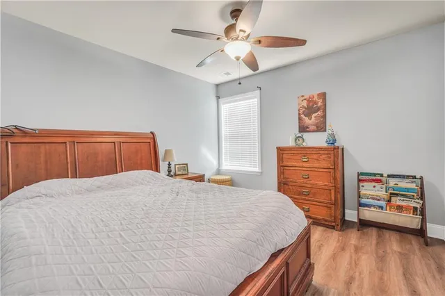 a bedroom with a bed and a ceiling fan
