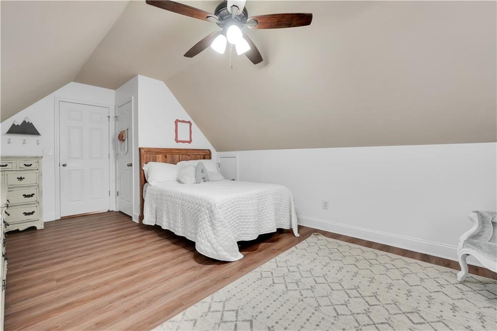 340 Roland Manor Drive Dacula, GA 30019 - Photo 42 of 50 a spacious bedroom with a bed and a ceiling fan