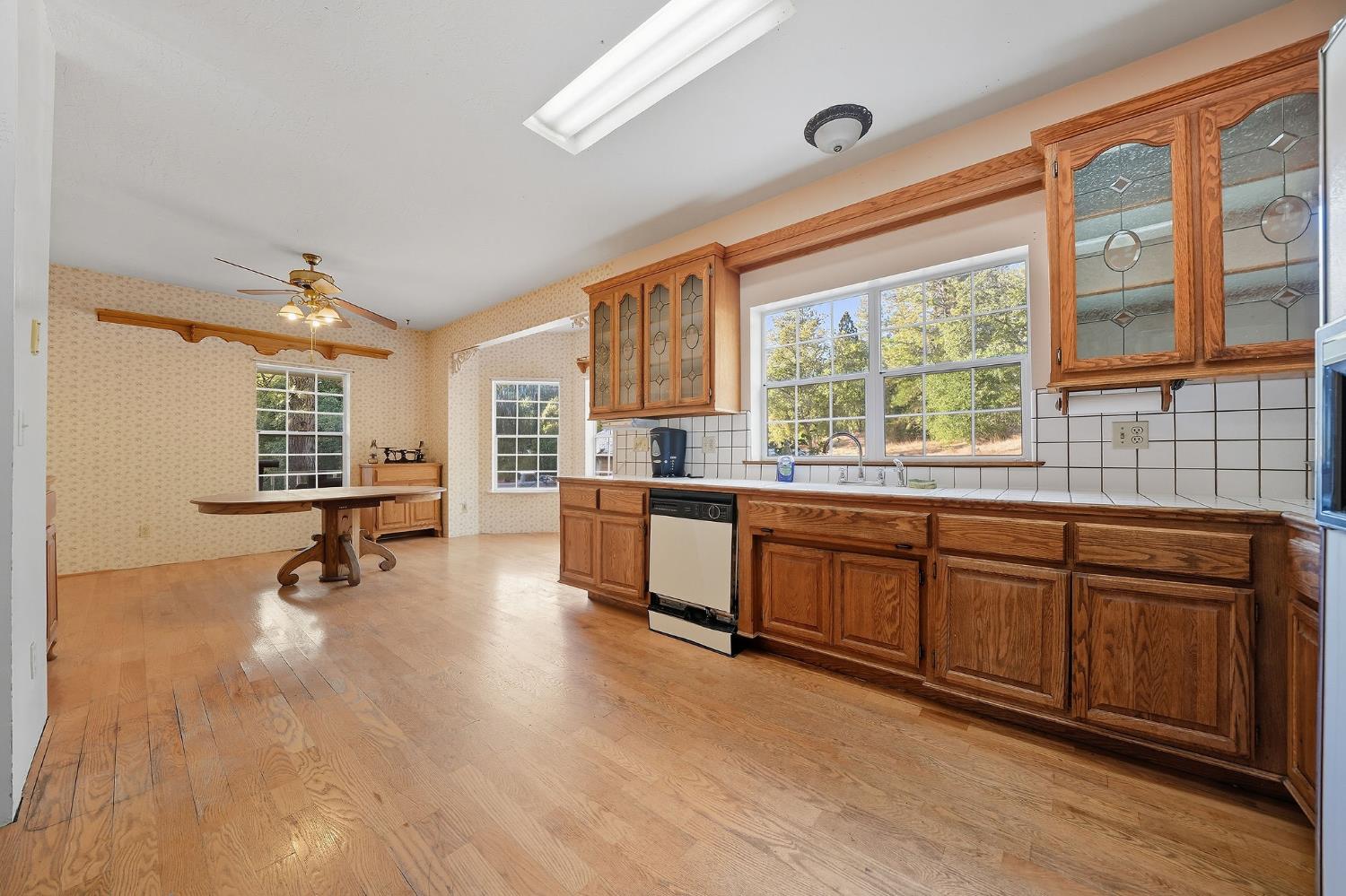 12810 New York Ranch Road Jackson, CA 95642 - Photo 36 of 56 a open kitchen with stainless steel appliances granite countertop a stove a sink dishwasher and white cabinets with wooden floor