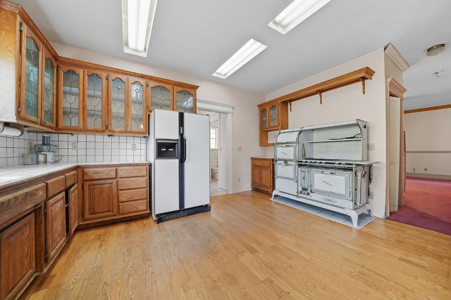 12810 New York Ranch Road Jackson, CA 95642 - Photo 38 of 56 a kitchen with granite countertop a refrigerator and a stove top oven