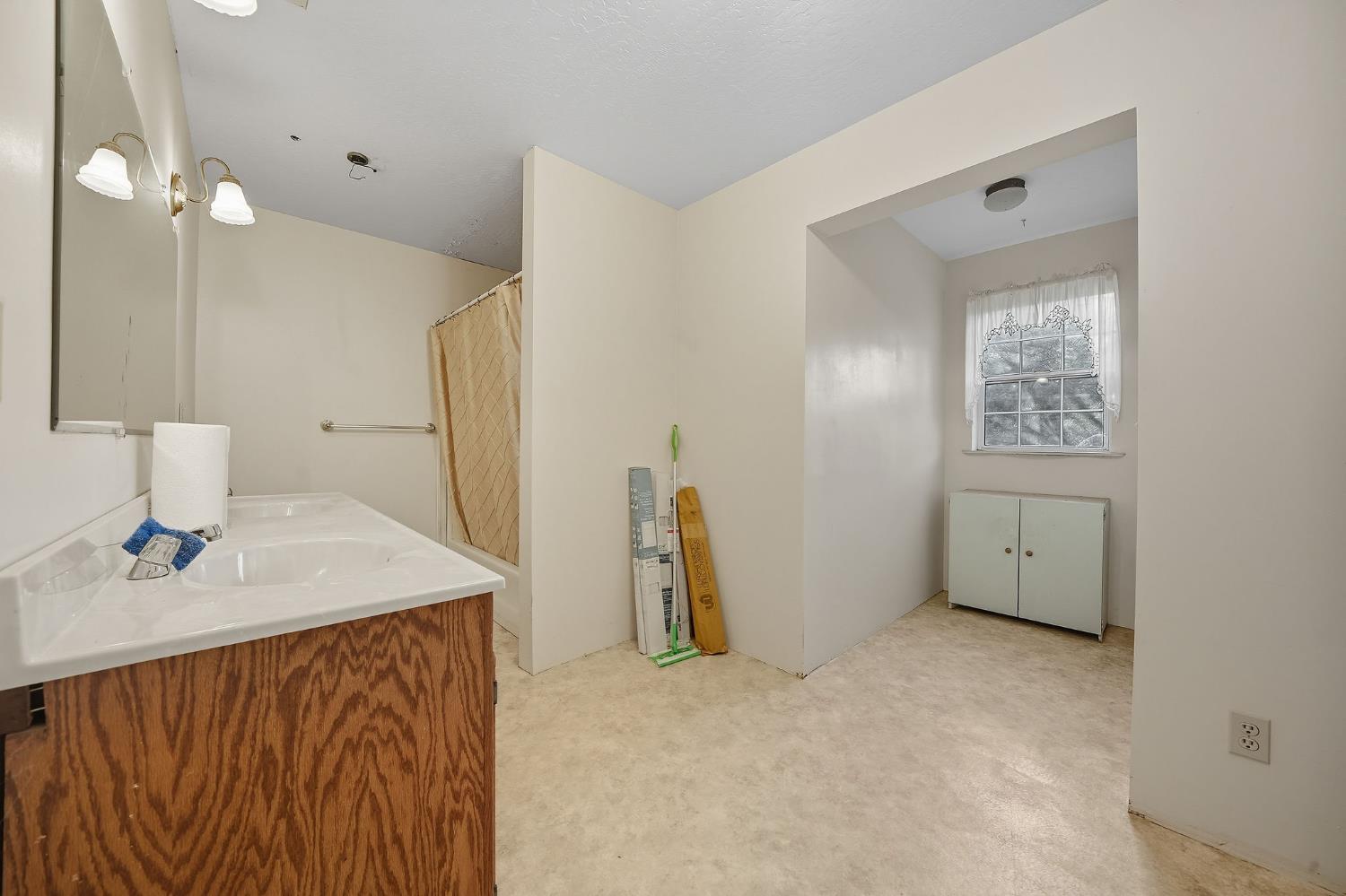12810 New York Ranch Road Jackson, CA 95642 - Photo 56 of 56 a bathroom with a sink vanity and a mirror