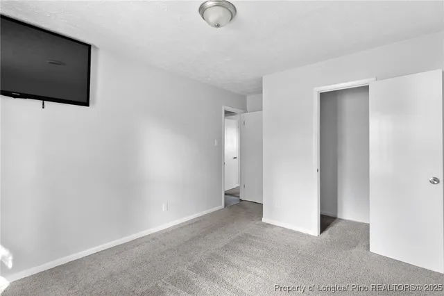 a view of an empty room with projector and screen