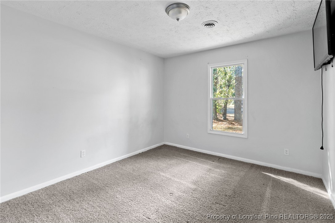 6838 Timbercroft Lane Fayetteville, NC 28314 - Photo 15 of 17 an empty room with windows