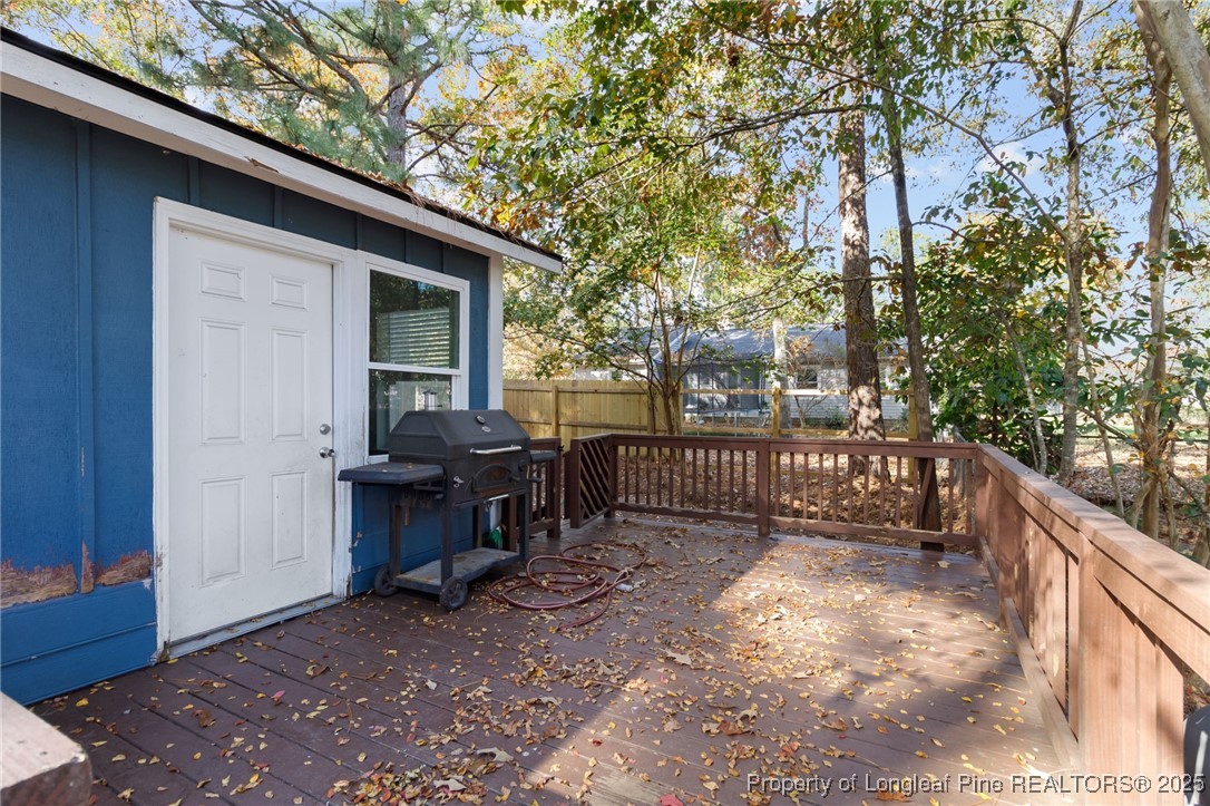 6838 Timbercroft Lane Fayetteville, NC 28314 - Photo 16 of 17 a view of a deck with a fence and a tree