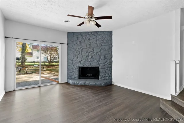 wooden floor in an empty room with a fireplace