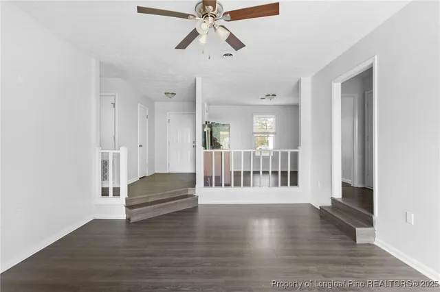 a view of entryway and hall with wooden floor