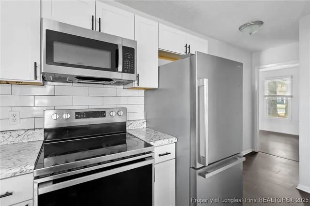 a kitchen with appliances and cabinets