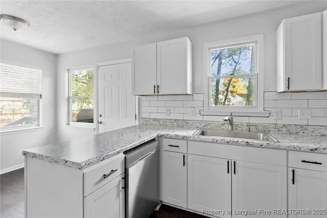 a kitchen with sink cabinets and a window