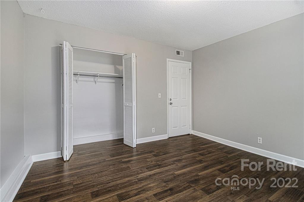 2624 Park Road, Unit E Charlotte, NC 28209 - Photo 12 of 26 a view of an empty room with wooden floor