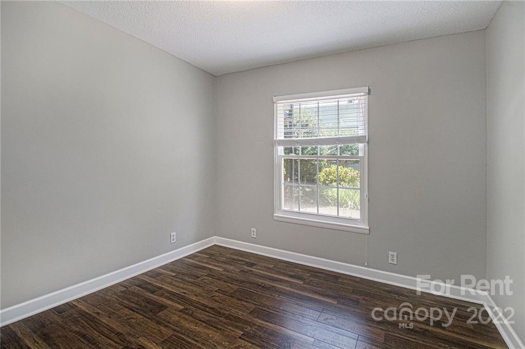2624 Park Road, Unit E Charlotte, NC 28209 - Photo 19 of 26 an empty room with wooden floor and windows