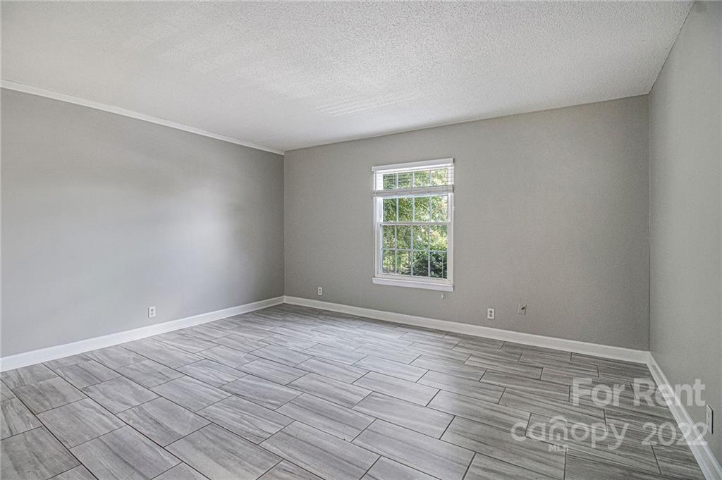 2624 Park Road, Unit E Charlotte, NC 28209 - Photo 21 of 26 wooden floor in an empty room with a window