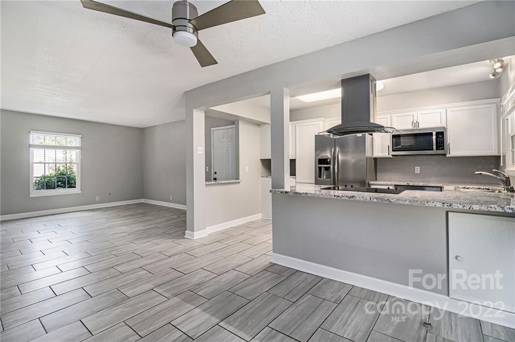 2624 Park Road, Unit E Charlotte, NC 28209 - Photo 6 of 26 a view of a kitchen with stainless steel appliances granite countertop a sink and cabinets