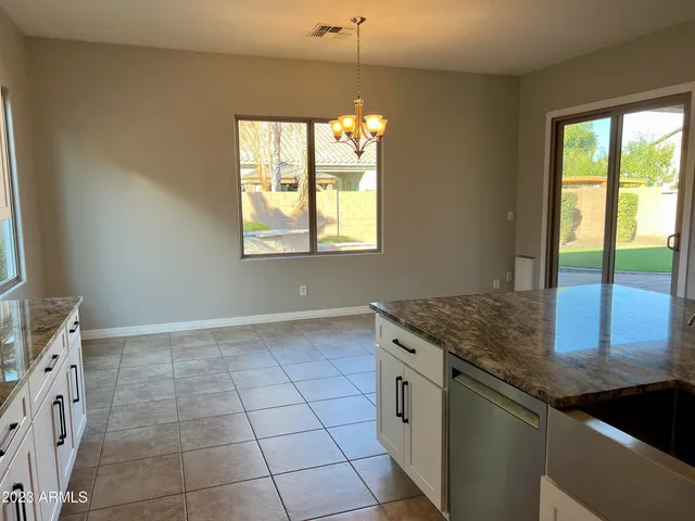 a large kitchen with stainless steel appliances granite countertop a stove a sink and a refrigerator