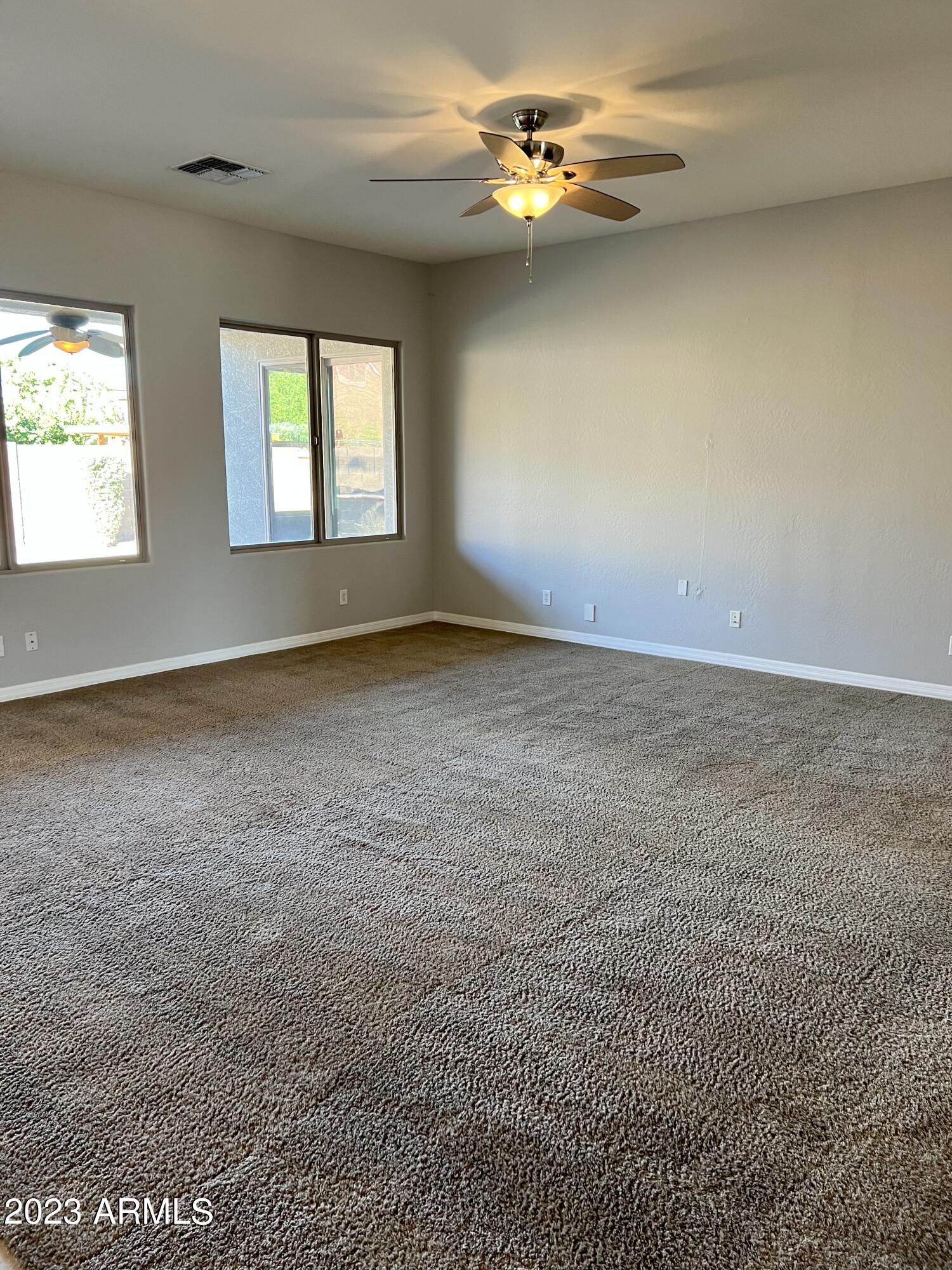 20296 East Sonoqui Boulevard Queen Creek, AZ 85142 - Photo 9 of 22 wooden floor in an empty room with a window
