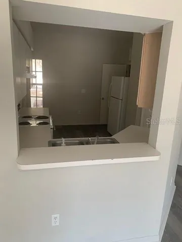 a room with wooden floor and a sink