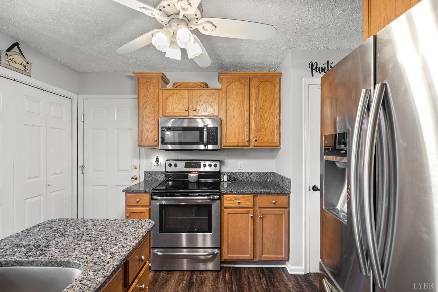 1324 Remington Ridge Drive Goode, VA 24556 - Photo 16 of 49 a kitchen with stainless steel appliances granite countertop a refrigerator a stove and a sink