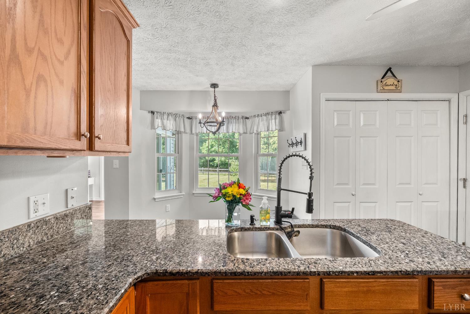 1324 Remington Ridge Drive Goode, VA 24556 - Photo 17 of 49 a kitchen with granite countertop a sink and a counter top space