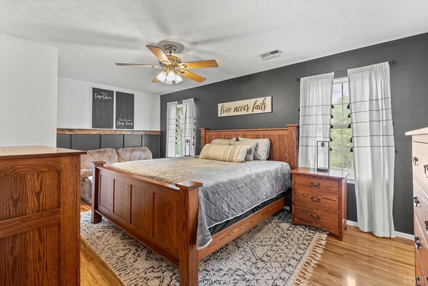 1324 Remington Ridge Drive Goode, VA 24556 - Photo 21 of 49 a bedroom with a bed and a dresser next to a window