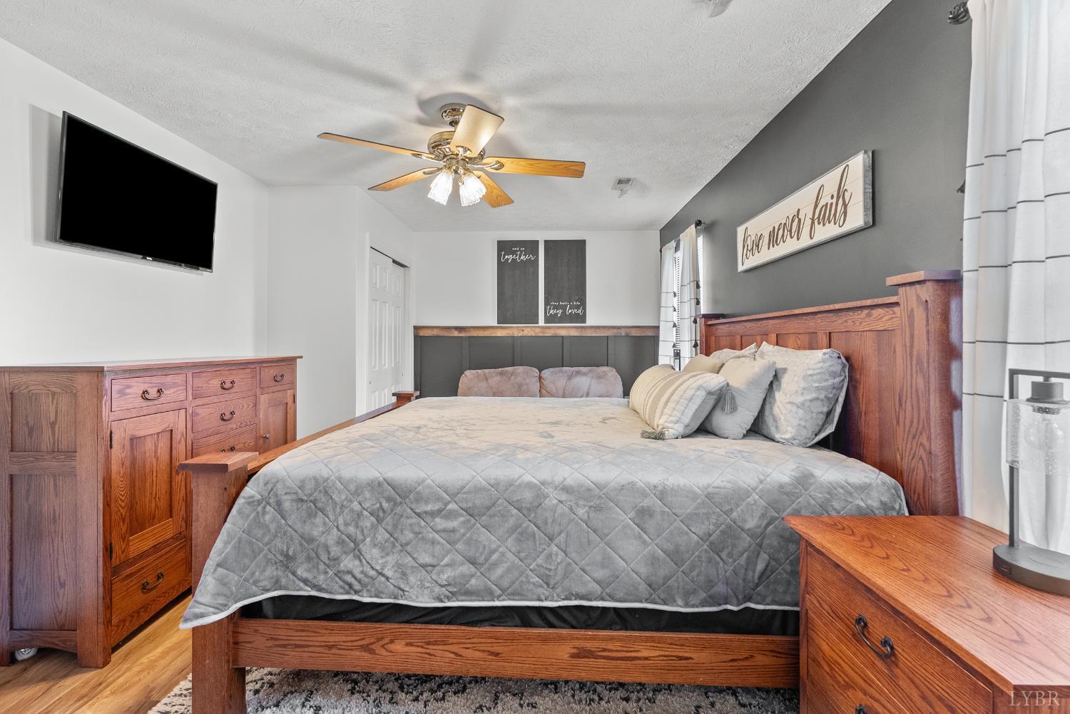 1324 Remington Ridge Drive Goode, VA 24556 - Photo 22 of 49 a bedroom with a bed and a flat screen tv