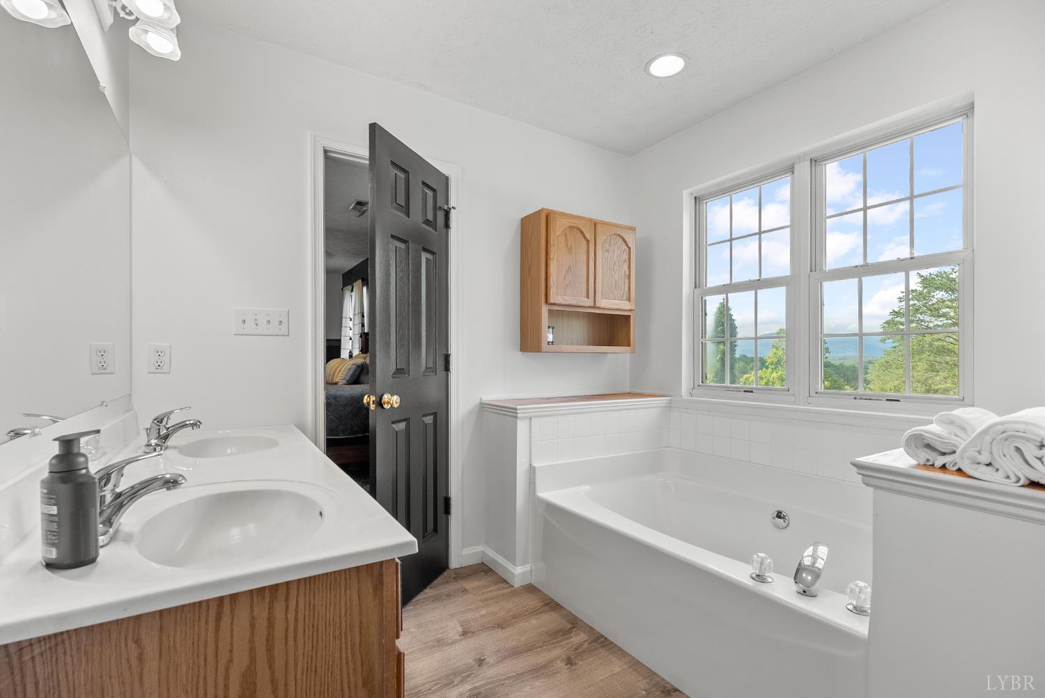 1324 Remington Ridge Drive Goode, VA 24556 - Photo 26 of 49 a bathroom with a tub sink and mirror