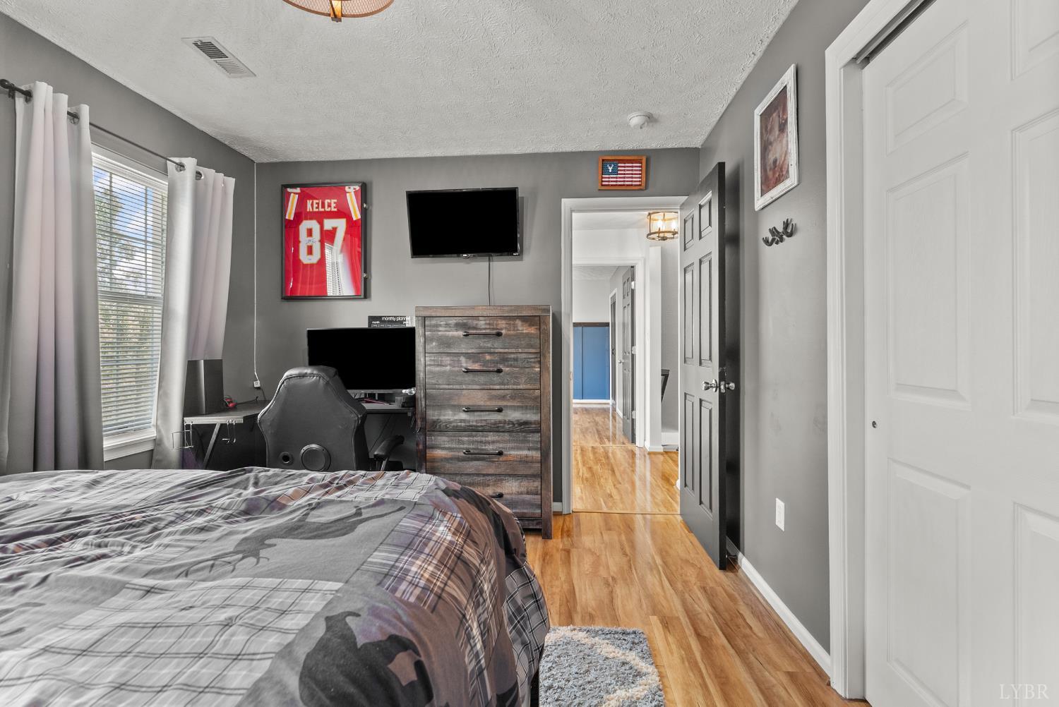 1324 Remington Ridge Drive Goode, VA 24556 - Photo 29 of 49 a bedroom with a bed and a flat screen tv