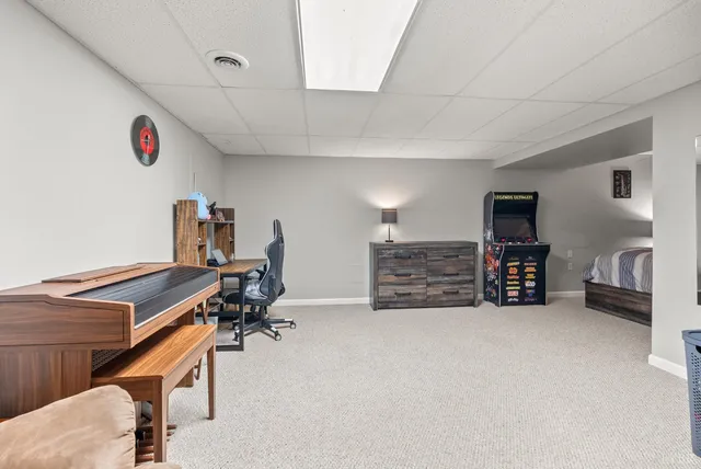 a room with furniture and a projector screen