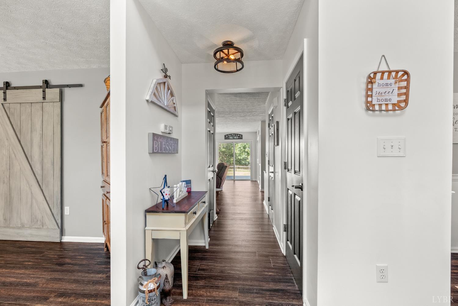 1324 Remington Ridge Drive Goode, VA 24556 - Photo 5 of 49 a hallway with wooden floor stairs and furniture