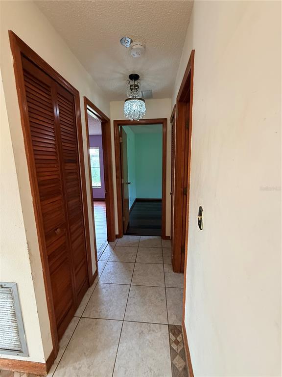 1771 Dublin Road Deltona, FL 32738 - Photo 13 of 17 a view of a hallway to rooms and stairs