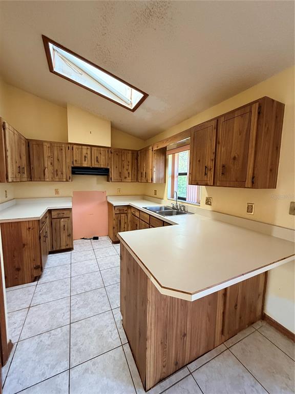1771 Dublin Road Deltona, FL 32738 - Photo 15 of 17 a kitchen with a stove a refrigerator and a sink
