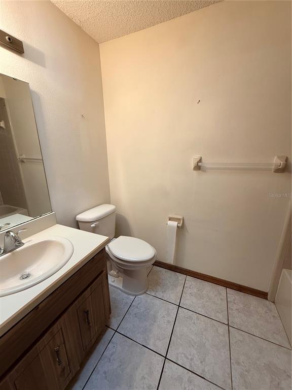 1771 Dublin Road Deltona, FL 32738 - Photo 6 of 17 a bathroom with a sink a toilet and a mirror