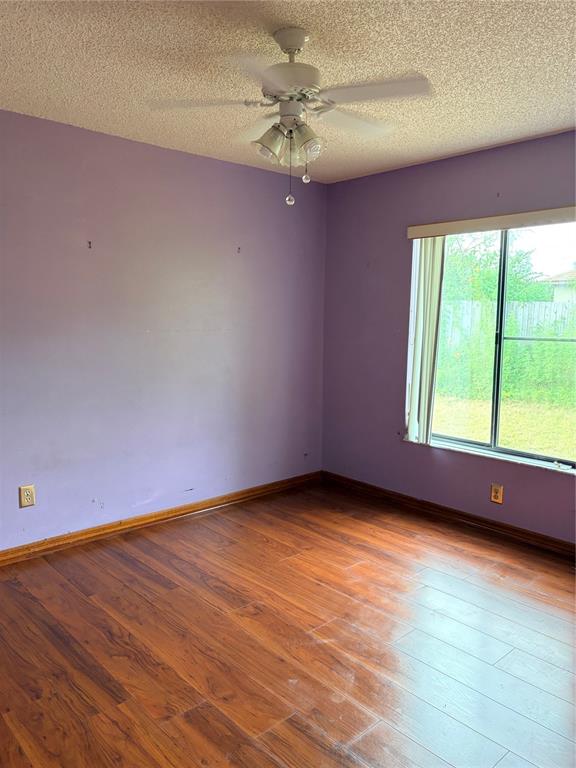 1771 Dublin Road Deltona, FL 32738 - Photo 10 of 17 wooden floor in an empty room with a window
