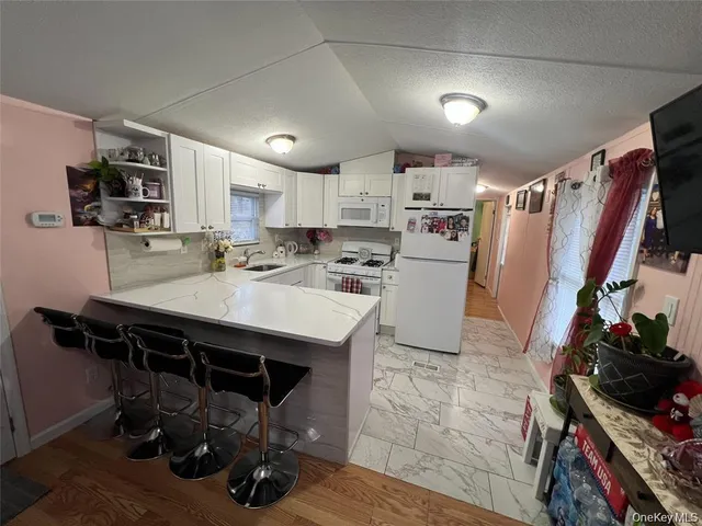 a kitchen with a sink a stove and chairs