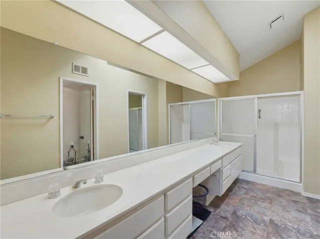 a bathroom with a double vanity sink and mirror