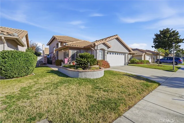 a front view of a house with a garden and plants
