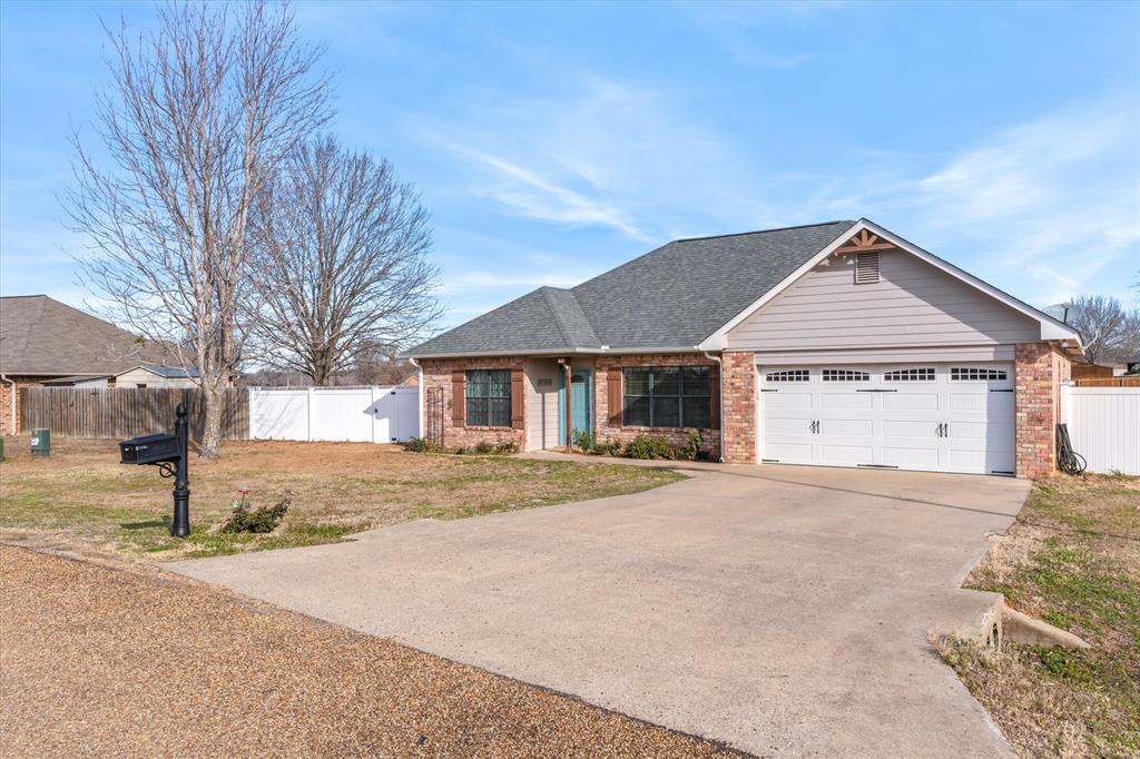 6030 Suncrest Drive Athens, TX 75752 - Photo 2 of 32 a front view of a house with a yard and garage