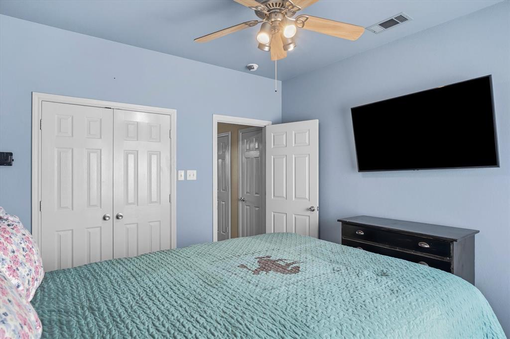 6030 Suncrest Drive Athens, TX 75752 - Photo 24 of 32 a bedroom with a bed and a flat screen tv