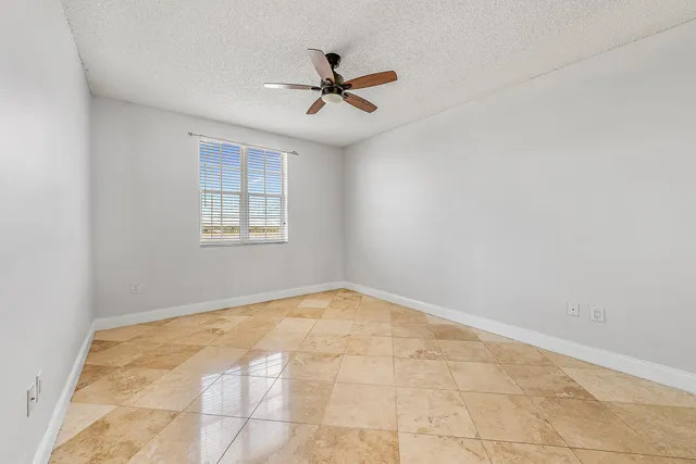 a view of a hallway with a ceiling fan