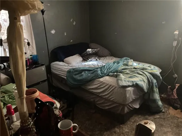 a bedroom with a bed and a mirror