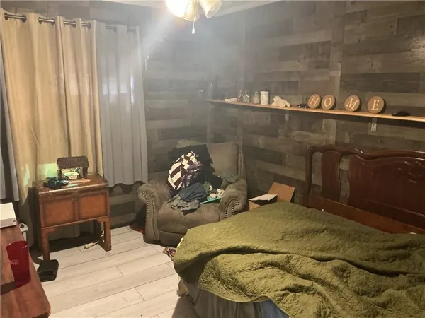 a bed sitting in a bedroom next to a window