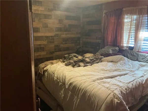 a bed sitting in a bedroom next to a window