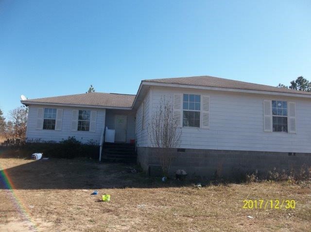 123 L R Davis Road Mauk, GA 31058 - Photo 1 of 1 a front view of a house with a yard