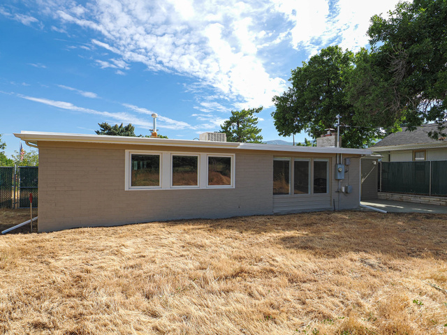 154 East 3000th Street South Bountiful, UT 84010 - Photo 35 of 37 Rear exterior featuring a flat roofline, neutral-toned siding, and multiple large windows