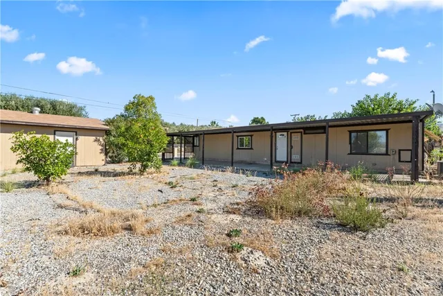 a view of a house with a yard covered in snow