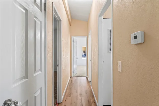 a view of a hallway with wooden floor and glass doors