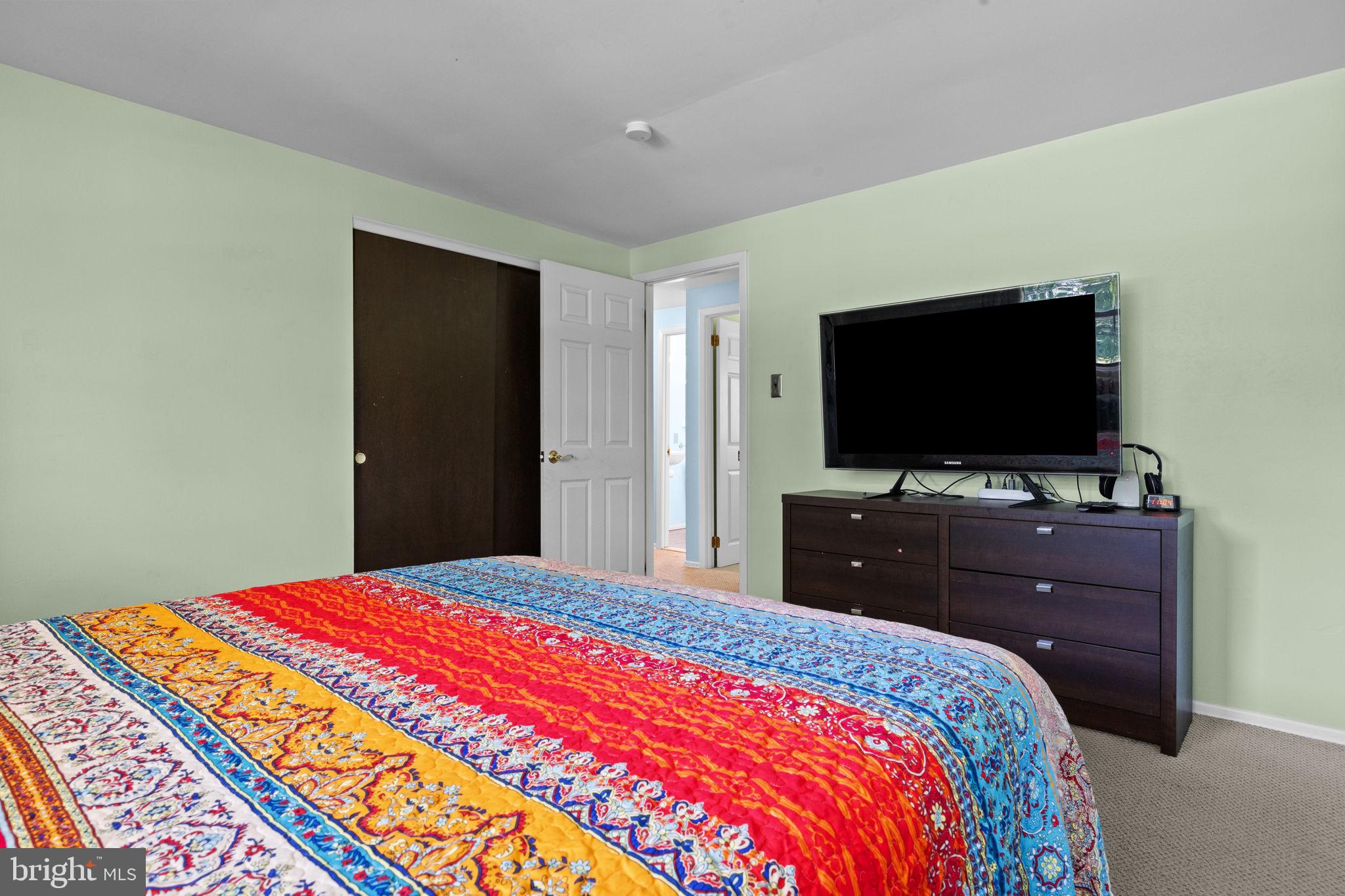 238 Centennial Road Warminster, PA 18974 - Photo 16 of 34 a bedroom with a bed and a flat screen tv