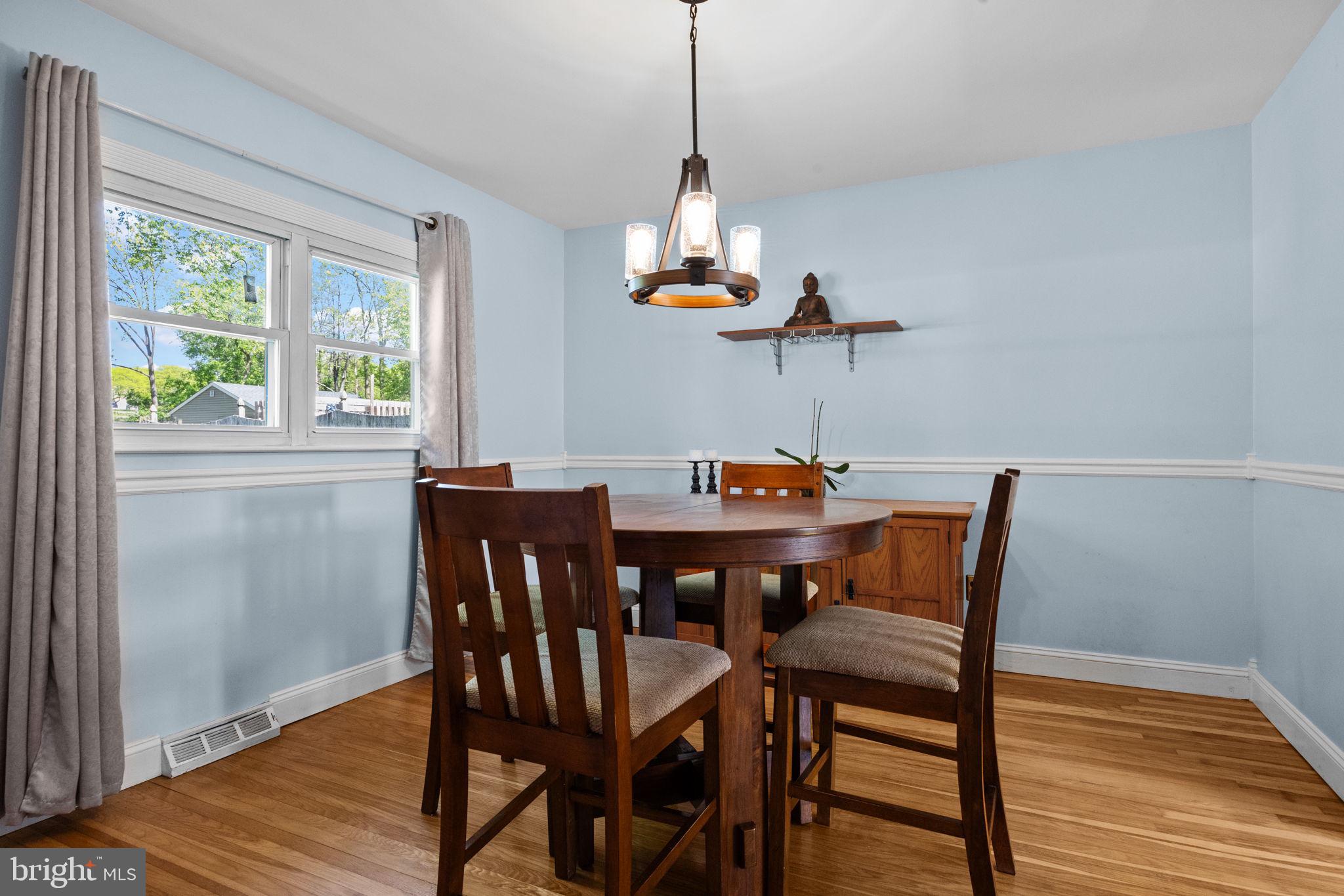 238 Centennial Road Warminster, PA 18974 - Photo 3 of 34 a dining room with furniture a chandelier and wooden floor